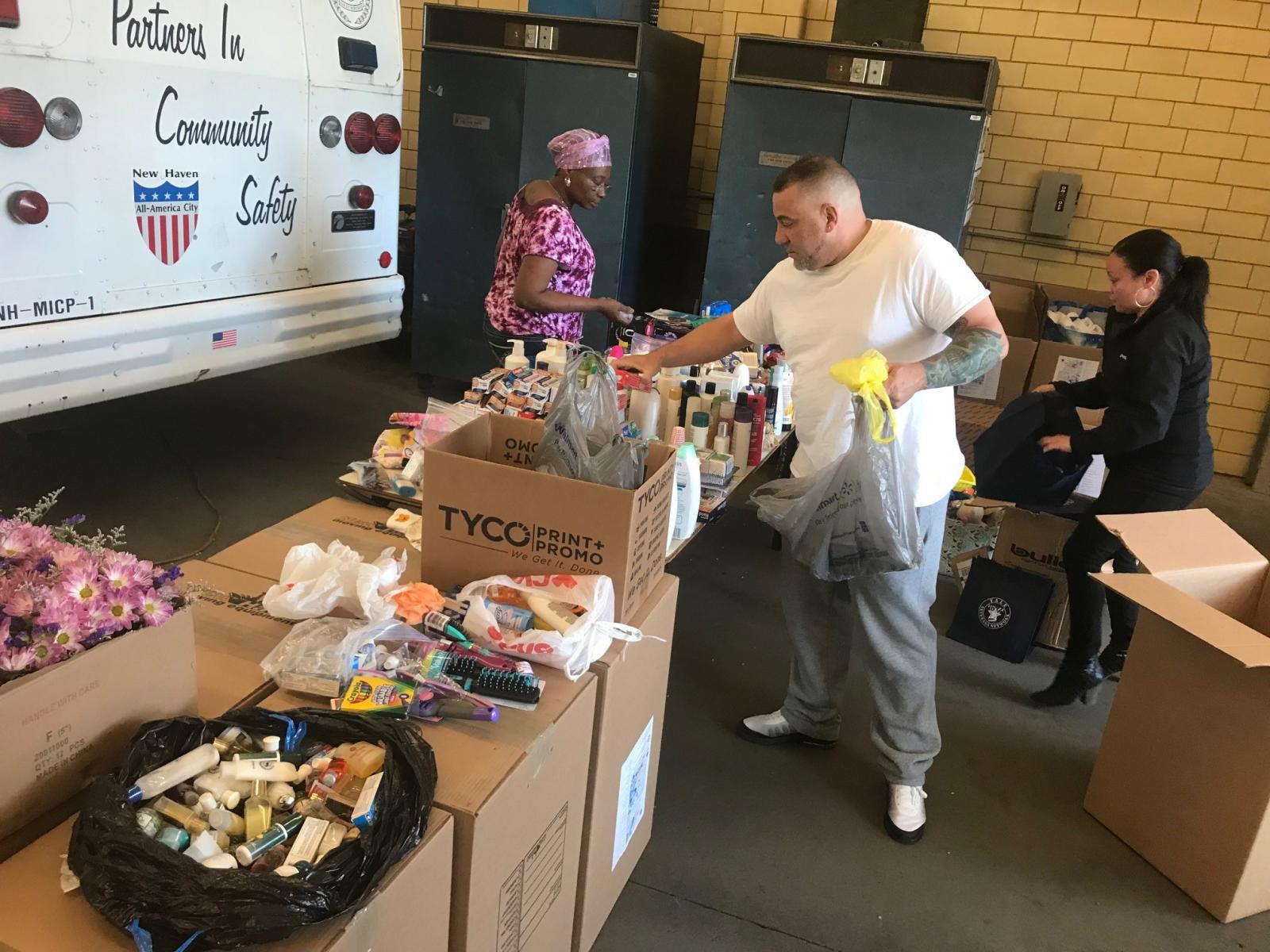 People putting together donation boxes.