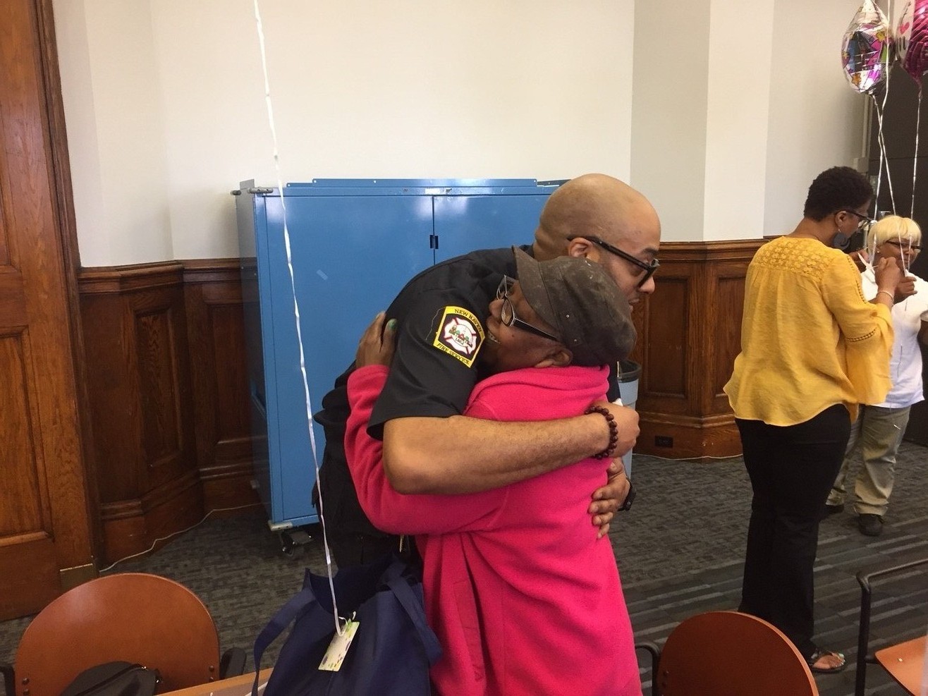 New Haven Fire Department gentleman hugging an elderly lady.