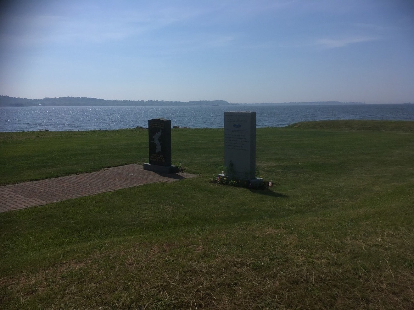 Two memorials, water in background.