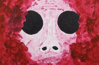 Red around a face with huge black eyes.