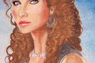 Close up of woman with brown curly hair.