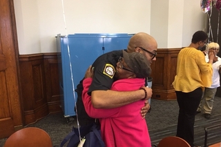 New Haven Fire Department gentleman hugging an elderly lady.