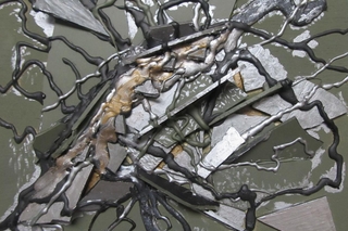 Smashed metal that resembles a military helmet.