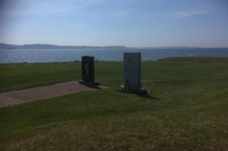 Two memorials, water in background.